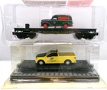 (2) Gauge Menards Flat Cars W/truck Loads Original Packages (lot 2943). Fixed Price $65.00.