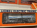 Lionel 17887- Flat W/armstrong Trailer- Lcca- Lnib. Fixed Price $19.00.