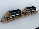 Atlas Scale 3 Rail Ttjx 82707 68 Foot Flat Car W/2 CT660 Cat Road Dump Trucks. Fixed Price $270.00.